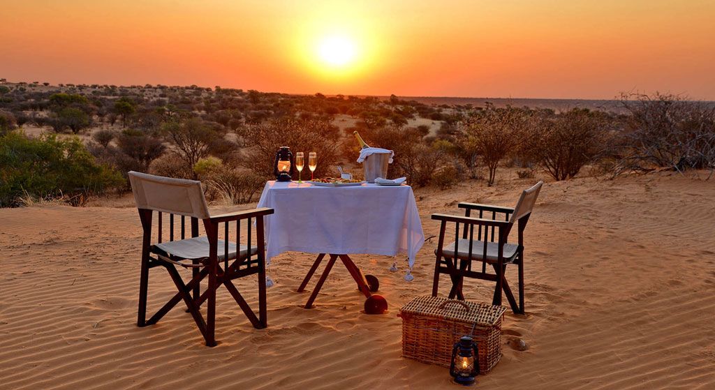 A table on the dune at sunset — Van Zylsrus Hotel