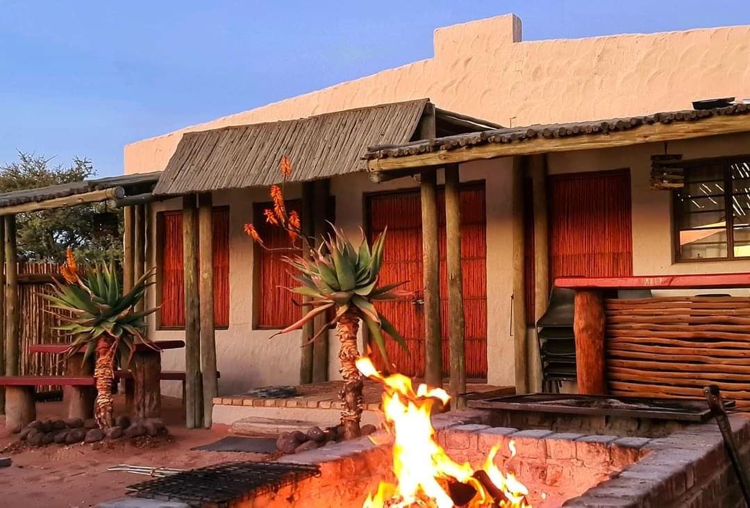 A fire burning outside a Kalahari field camp